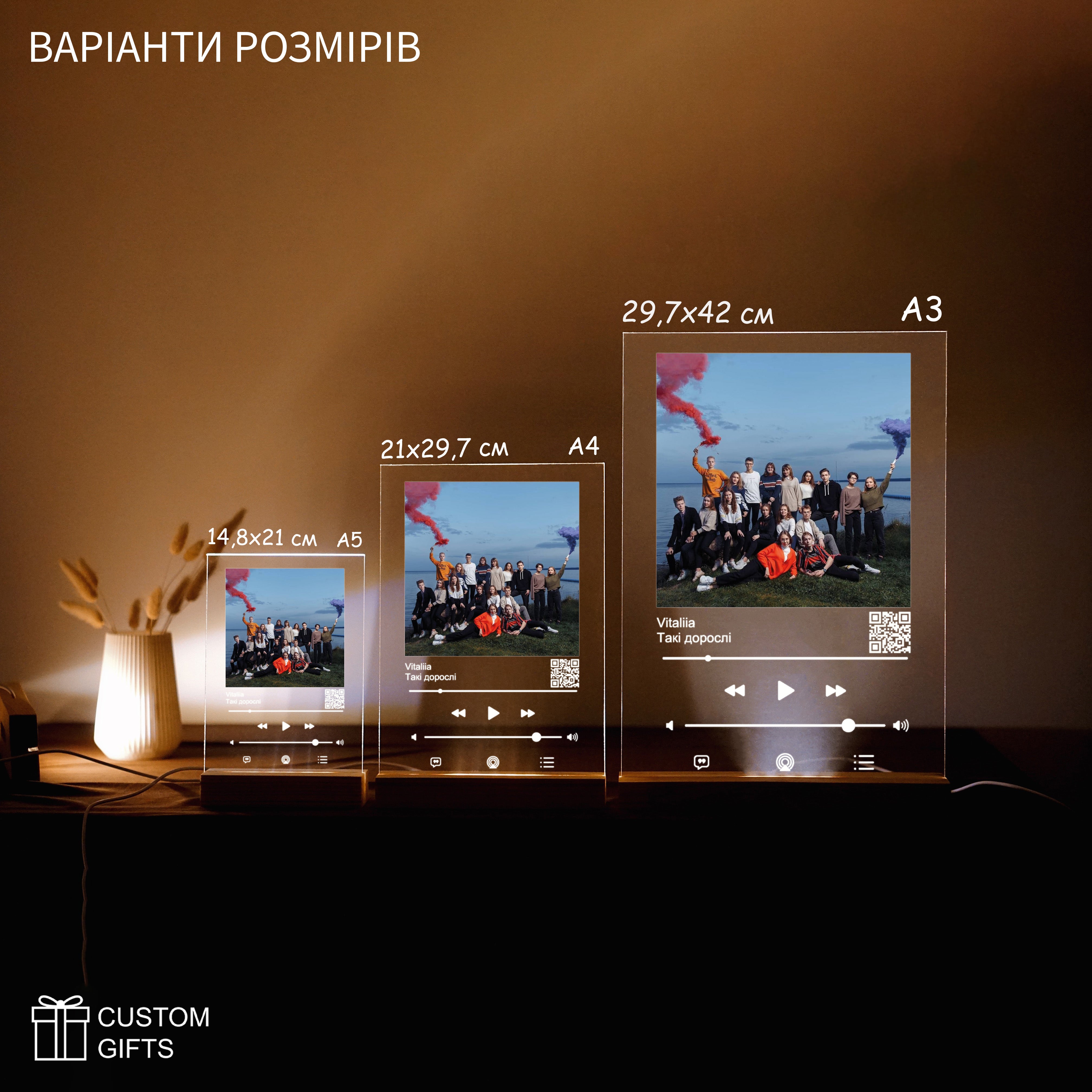 Apple Music poster size options displayed with custom photos and song titles on a stylish table setup.